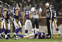 Urlacher Stands over Favre