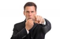 Businessman blowing whistle