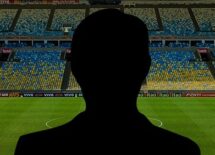 Silhouette of a coach with soccer field on the background