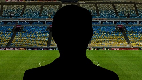 Silhouette of a coach with soccer field on the background