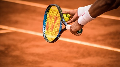 Photo of a tennis player's hand about to serve the ball