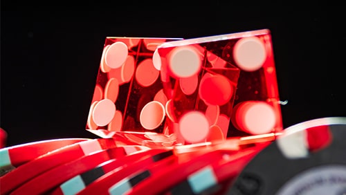 Zoomed photo of dice over poker chips. Concept of gambling