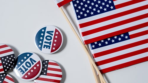 Vote pins and American Flags. Concept of Voting and Election