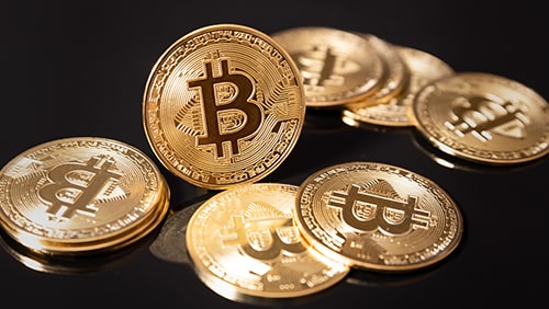 Photo of Bitcoins on top of a black surface