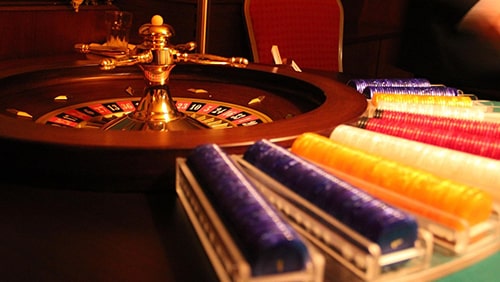 Photo of a roulette and poker chips. Concept of gambling