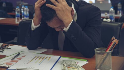Businessman struggling Financial Report