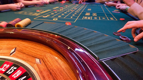 Roulette table with people playing