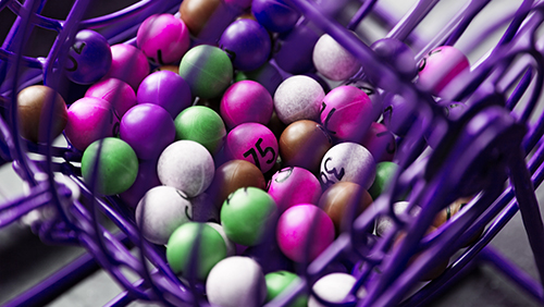 Purple lottery game in close-up with different colored balls with numbers