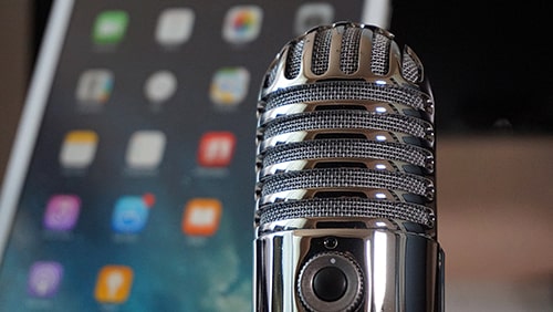 Close-up of a microphone against a blurred background of a tablet