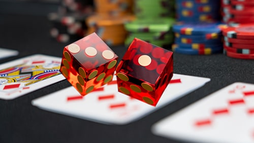 Poker game and rolling dices at the casino gambling table