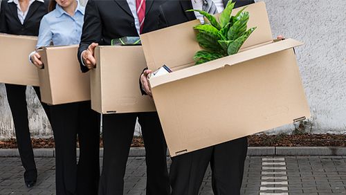 Group of employees walking away with their belongings