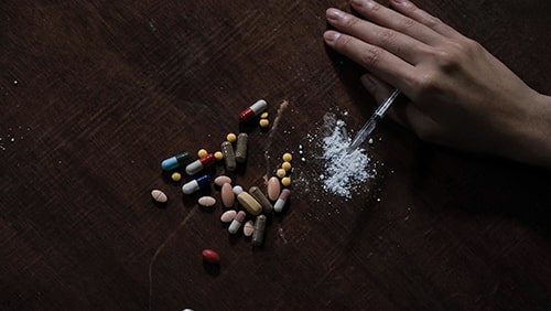 Top view of different drugs on a wooden table