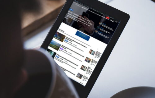 A man browsing CalvinAyre website on a tablet