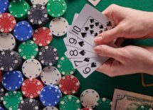 A dealer shuffling poker cards. poker table a lot of money and chips