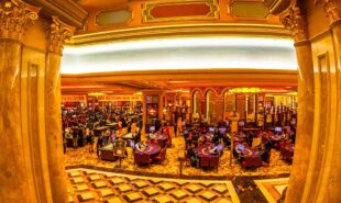 Aerial view of black jack tables and gamblers inside of a Casino in Macau