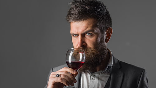 Bearded man with alcohol. Man in suit drinks wine. Alcohol