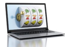 3d render illustration. Laptop with slot machine. Casino online games concept.