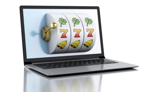3d render illustration. Laptop with slot machine. Casino online games concept.