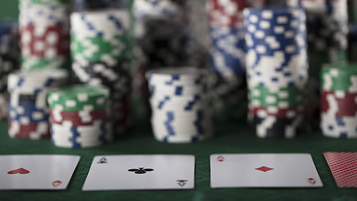 Casino theme, cards and stack of chips on glass table