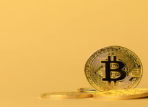 gold-bitcoin-cryptocurrency-coins-on-yellow