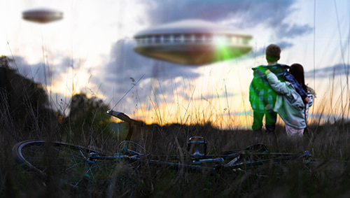 Two children staring at some unidentified flying objects in the sky