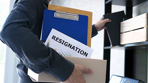 businessman cleaning his office with resignation letter inside his box