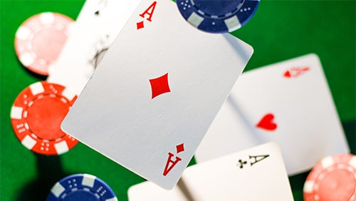 Zoomed photo of poker cards and chips thrown in the air