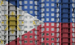 Philippines flag depicted in paint colors on multi-storey residental building under construction.