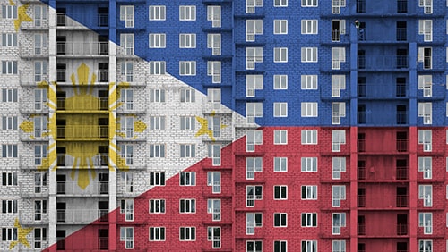 Philippines flag depicted in paint colors on multi-storey residental building under construction.