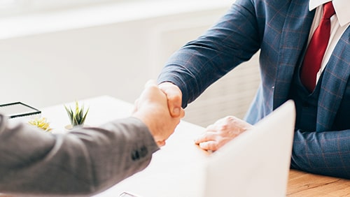 Zoomed photo of business men shaking hands