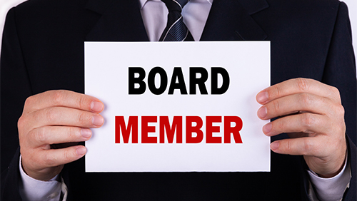 businessman holding board member sign