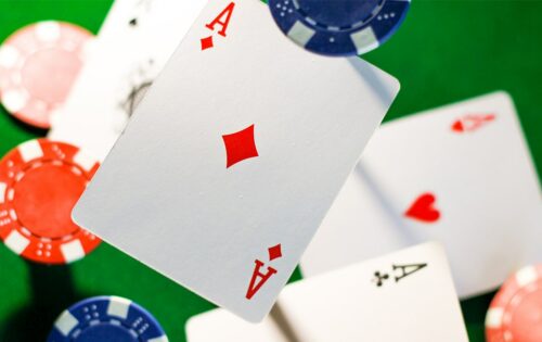 Zoomed photo of poker cards and chips thrown in the air