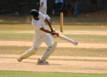 A cricket player hitting the ball