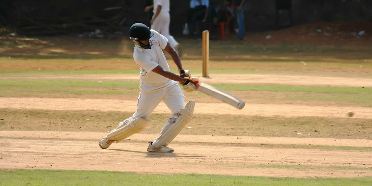 A cricket player hitting the ball