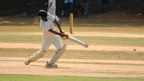 A cricket player hitting the ball