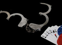 Open handcuffs and casino chips and playing cards