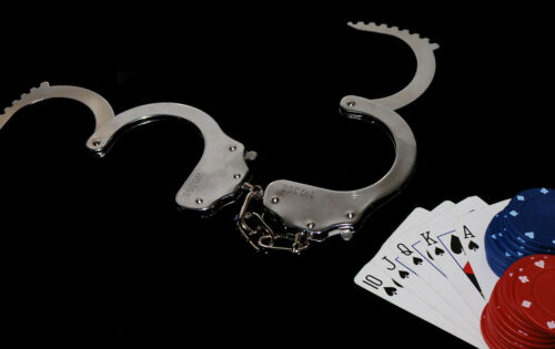 Open handcuffs and casino chips and playing cards