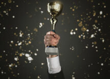 businessman holding trophy