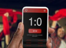 Device screen with mobile app for betting and score.