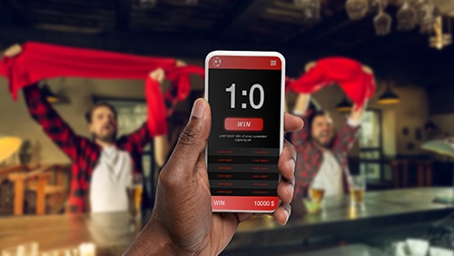 Device screen with mobile app for betting and score.