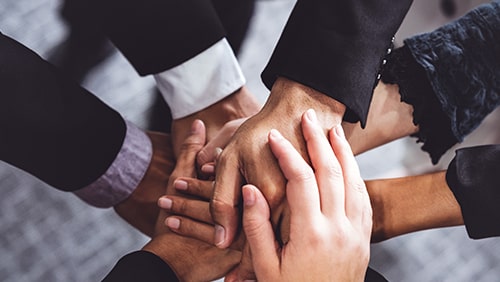 business people stacking hands together