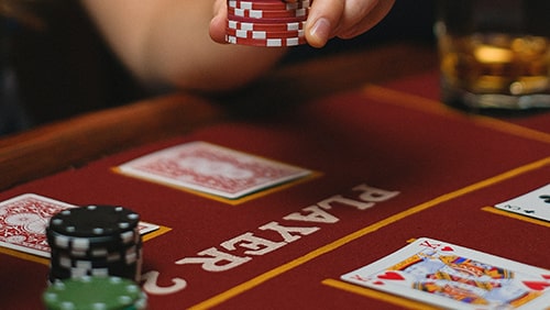 Close up photo of a poker table with cards and chips