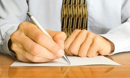 Businessman writes a pen on an empty paper