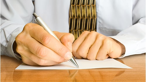 Businessman writes a pen on an empty paper