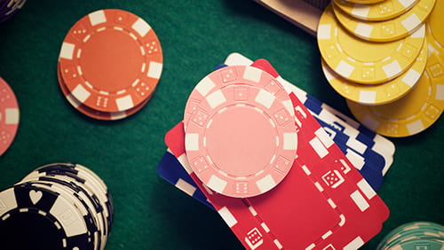 Casino chips stacking on a green felt.