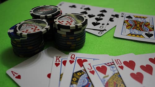 Casino chips and cards on a green table