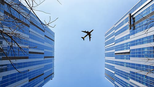 Airplane on top of two buildings