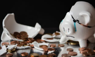 Broken piggy bank with coins scattered
