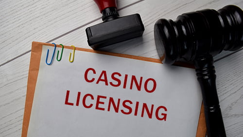 Casino Licensing text with document brown envelope and stethoscope isolated on office desk