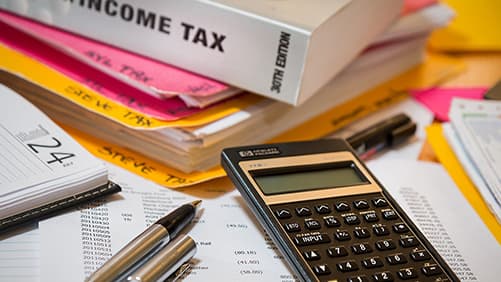 Calculator with Income tax book on a table